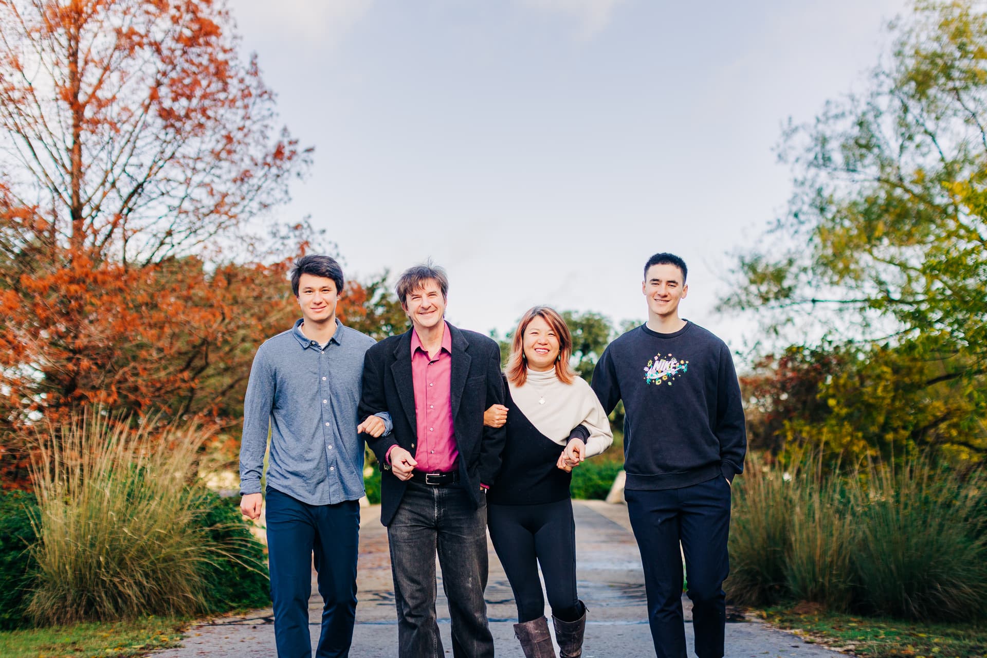 Family laughing together naturally during a candid moment in a park