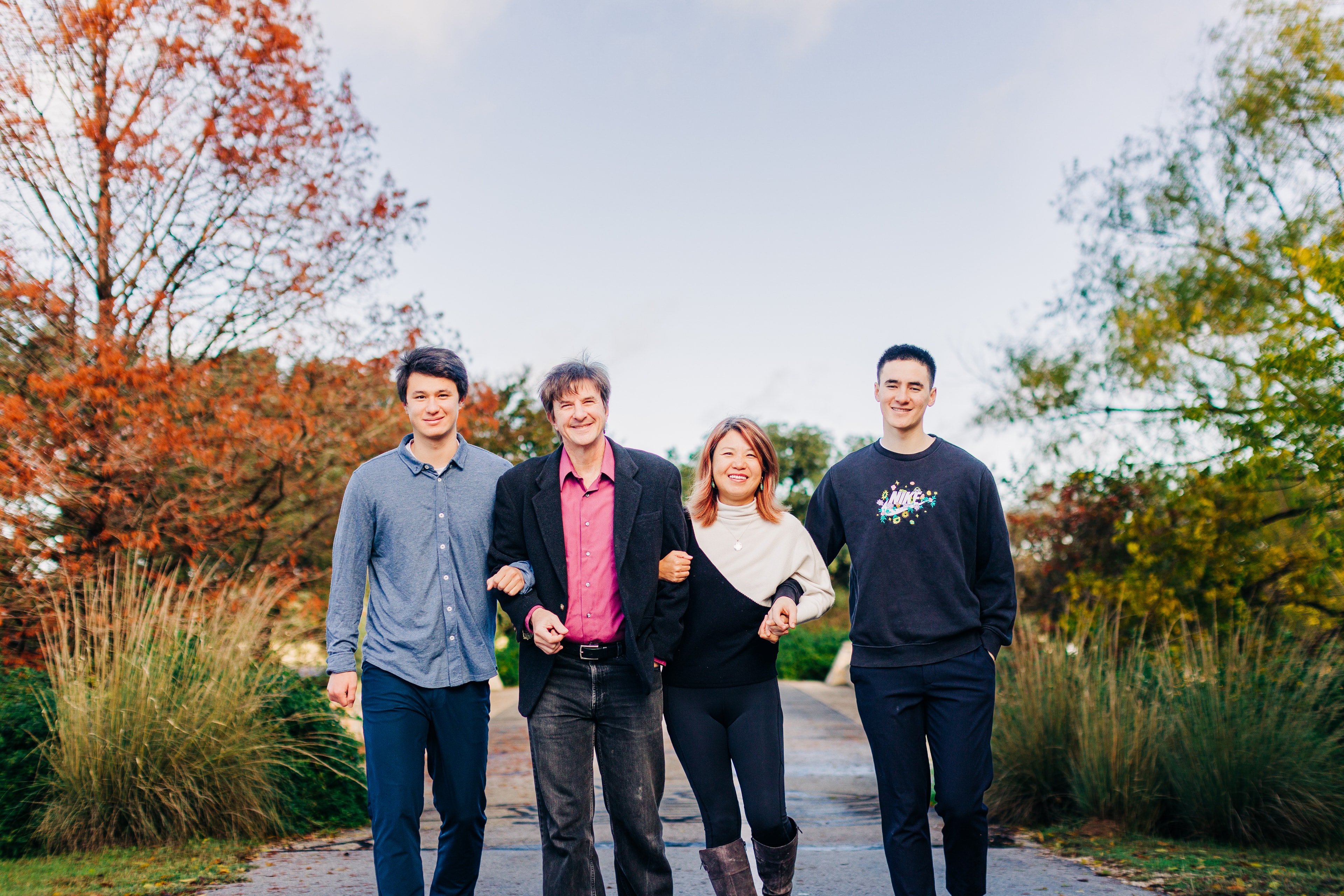 Family laughing together naturally during a candid moment in a park