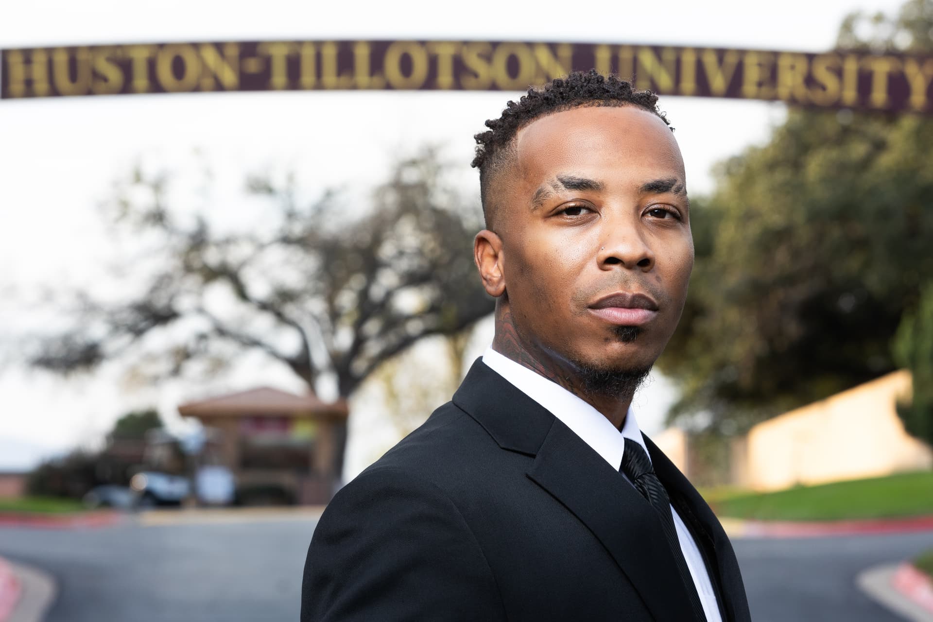 Professional headshot showing real personality and expression — a subject with a genuine, serious expression and natural skin texture, the kind of authentic expression that only comes from a real interaction with a photographer