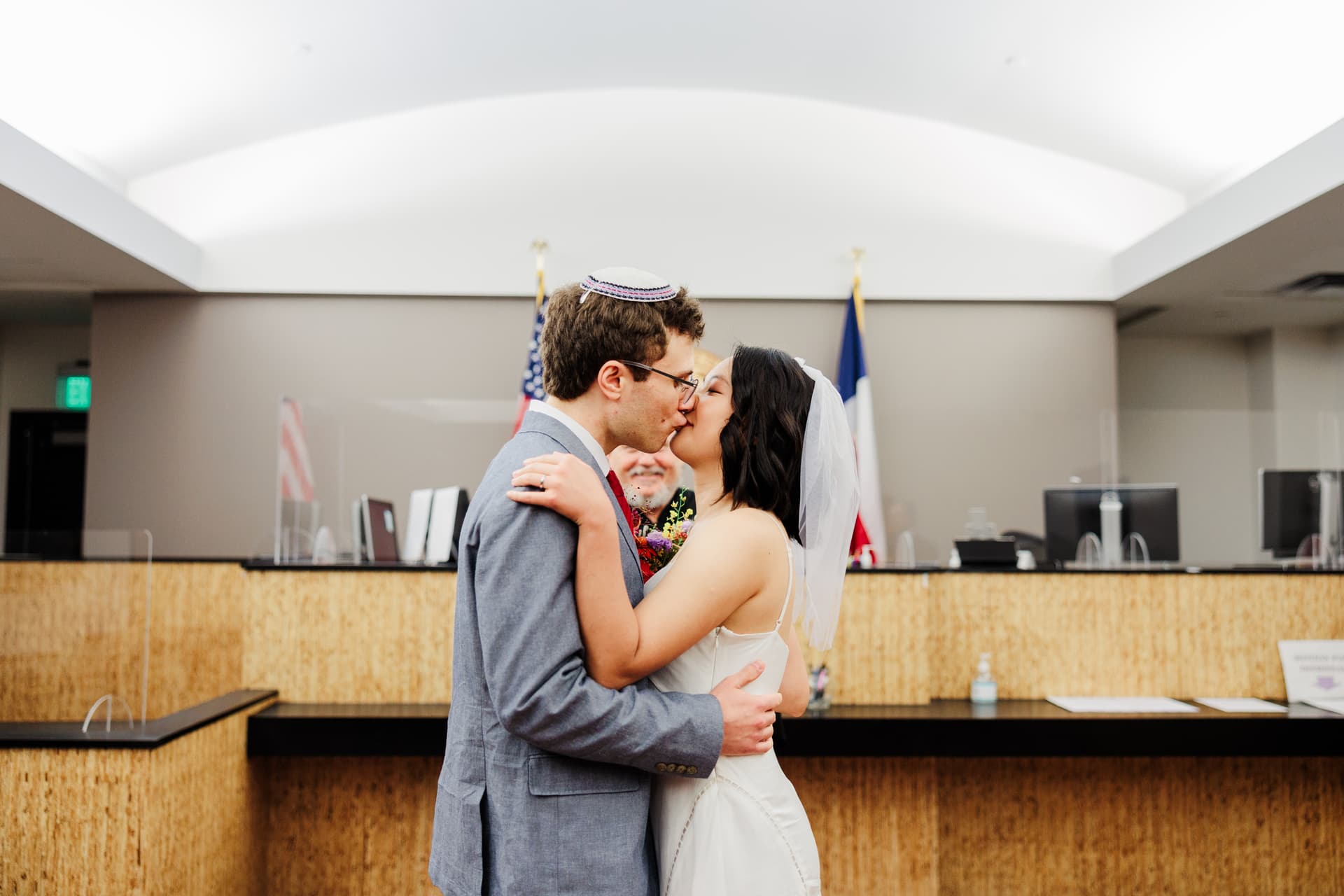 Couple kissing after saying their vows at another Austin Courthouse Precinct inside the Courthouse